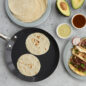 Crepe Pan with tortillas and plated tacos and avocados, overhead