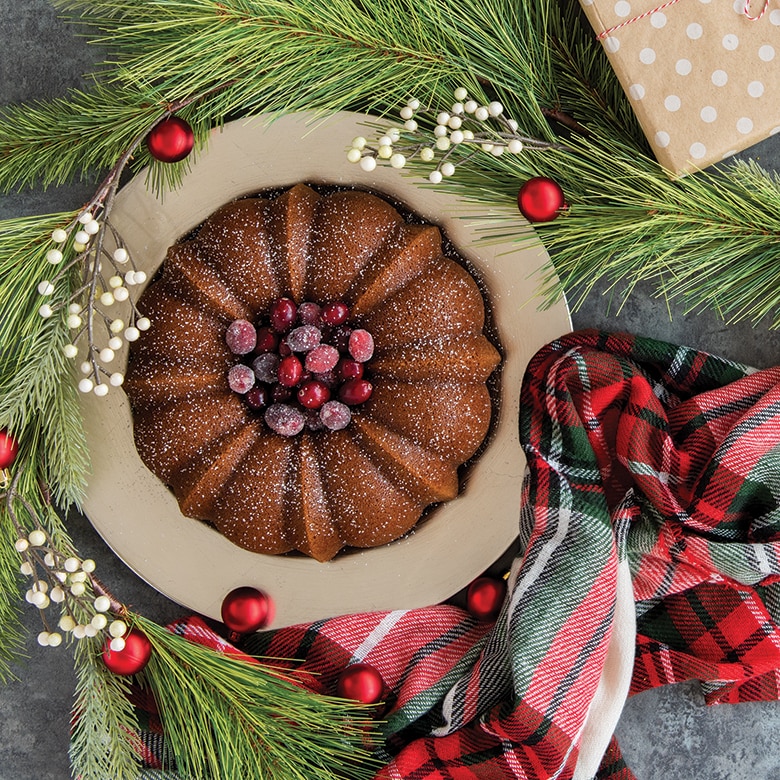 Image of baked ornament cakelets on a cooling rack with pan on surface