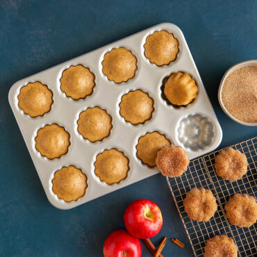 Mini Bundt® Cupcake Pan, cupcakes in pan and on cooling rack, with apples and cinnamon sticks