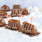 Baked train cake decorated in frosting, formed in a train line on a pretzel track.