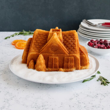 Gingerbread House Bundt® cake sitting on plate, plain.