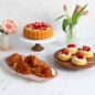 Group shot of Shortcake Baskets Cakes with sliced Strawberries, Charlotte Cake with Sliced Strawberries, and Baby Bunny Cakelets