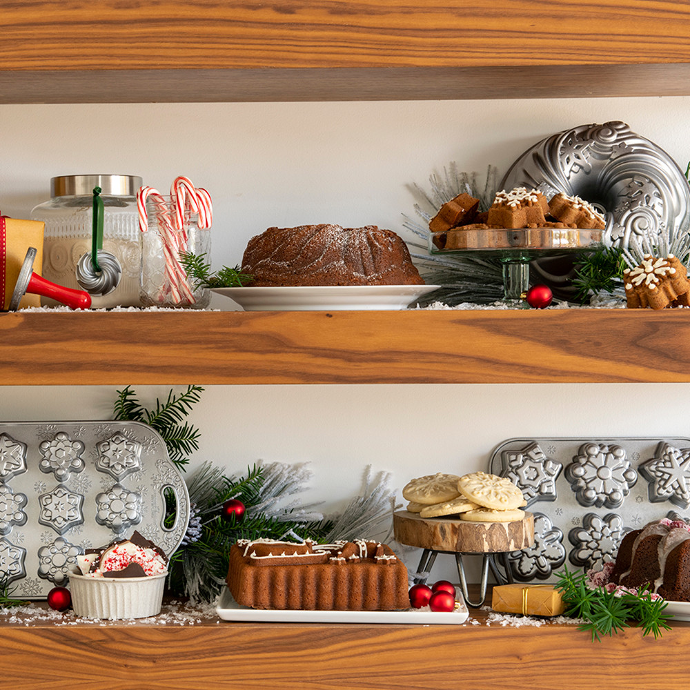 Image of baked ornament cakelets on a cooling rack with pan on surface