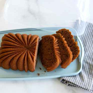 Sliced baked fluted loaf cake on the Cake Keeper