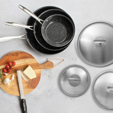 Basalt 6 Piece Skillet Set with Lids, cutting board with cheese and tomatoes