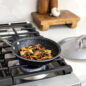 Basalt 2 Piece 8" Sauté Skillet on stovetop with mushrooms, lid sitting on countertop