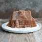 Powdered sugar being sprinkled onto gingerbread House Bundt, moving GIF