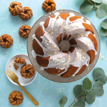 75th Anniversary Braided Bundt glazed with baked Braided Mini Bundts on blue surface