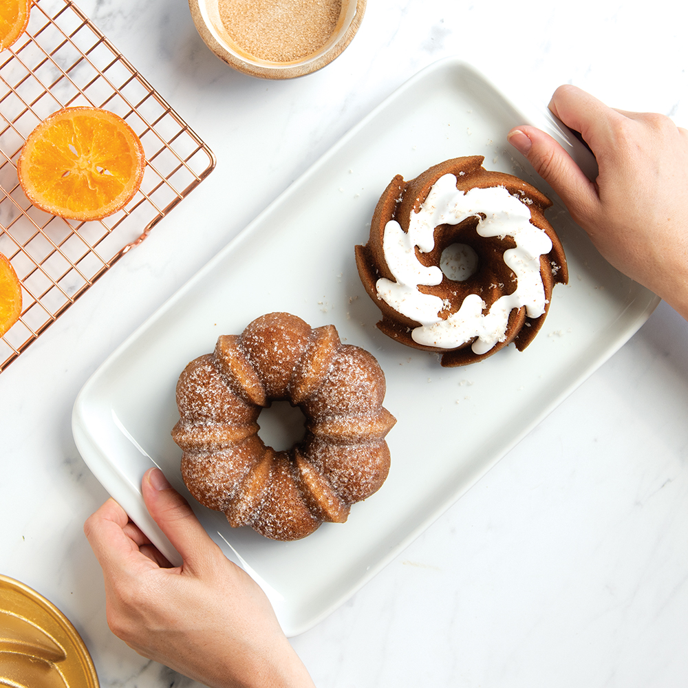 Image of baked cakes made in Classic Duet Pan, some glazed and sugared. 