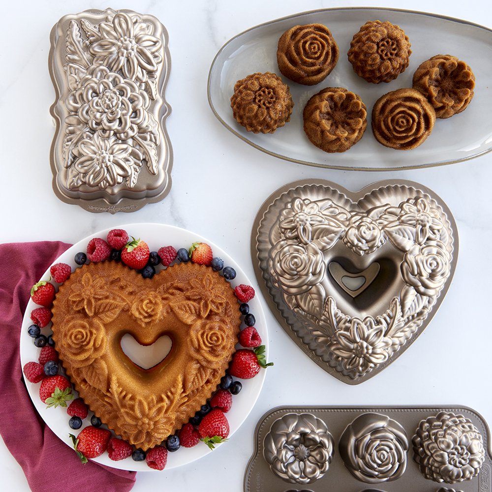 Image of baked floral bundt cakes and cakelets with detailed cast pans in a cute floral themed scene