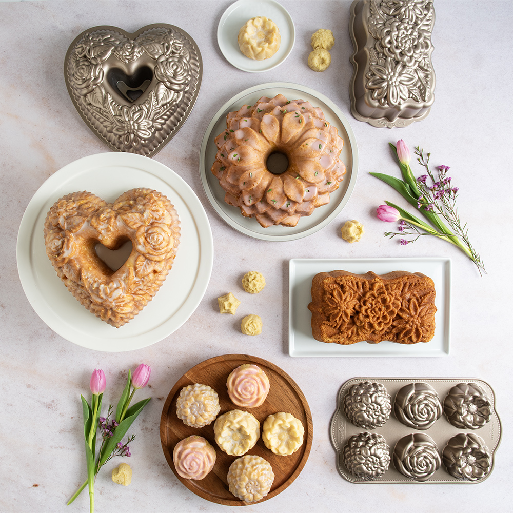 Image of baked ornament cakelets on a cooling rack with pan on surface